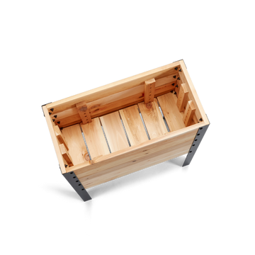 Wooden crate with metal legs on a white background