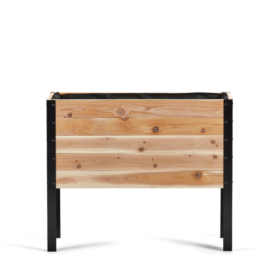 Wooden planter box with black metal frame on a white background