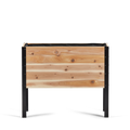 Wooden planter box with black metal frame on a white background