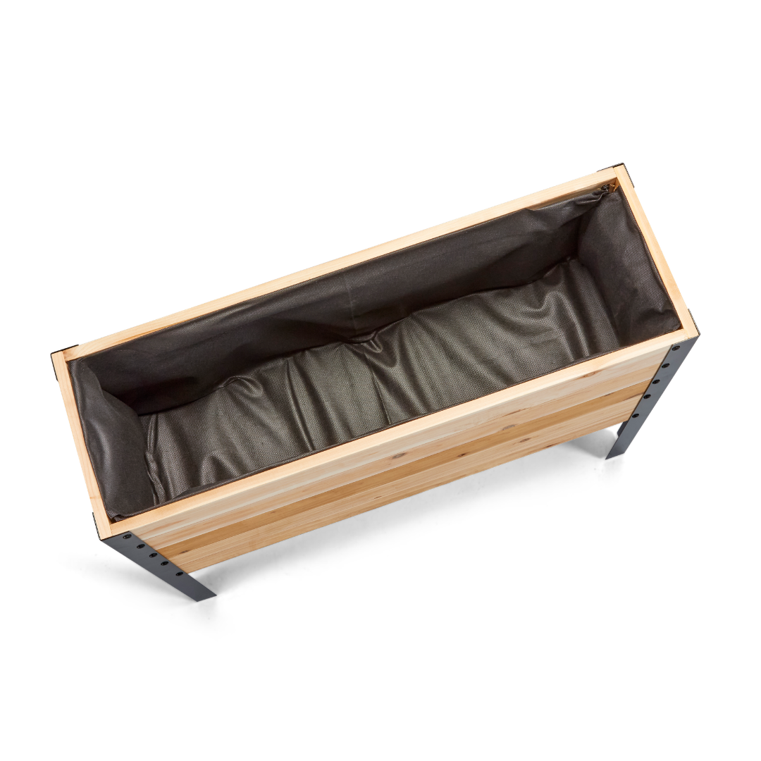 Wooden planter box with brown liner on a white background