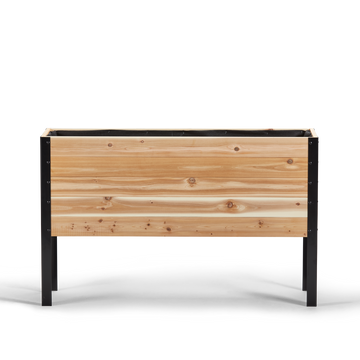 Wooden planter box with black metal frame on a white background