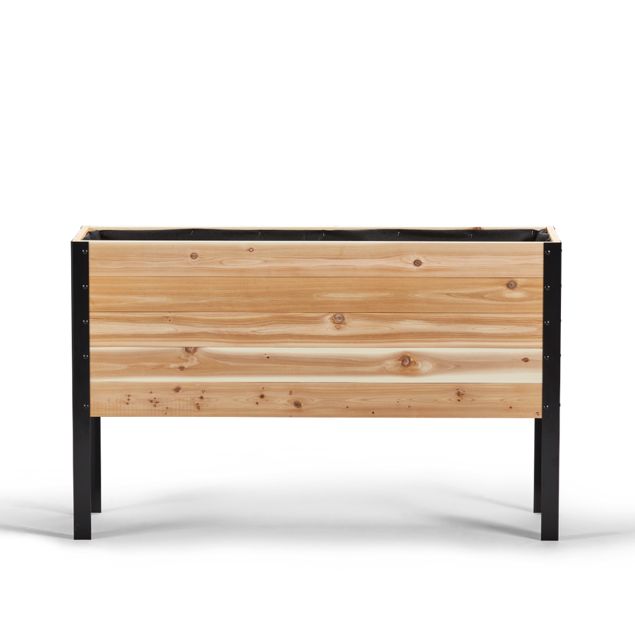 Wooden planter box with black metal frame on a white background
