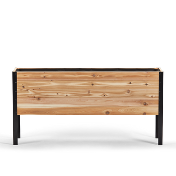 Wooden planter box with black metal frame on a white background